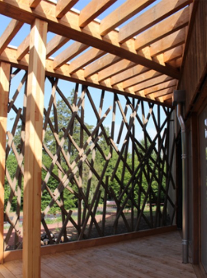 Maison en bois Yssingeaux (43) — terrasse couverte avec pergola bois et claustra branchage